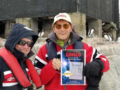 Gringo book signing with the peguins. With the President of Polar Latitudes, John Mckeon, Port Lockroy, Antarctica