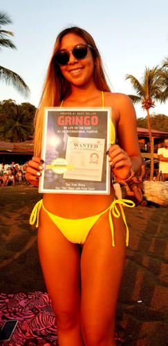 Young lady on Costa Rica beach with GRINGO book cover