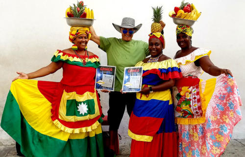 Dan Tito Davis with colorfully dressed women in the streets of Cartagena, Colombia