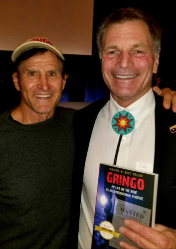 Dan Tito Davis presenting a copy of GRINGO to the Governor of Wyoming, Mark Gordon